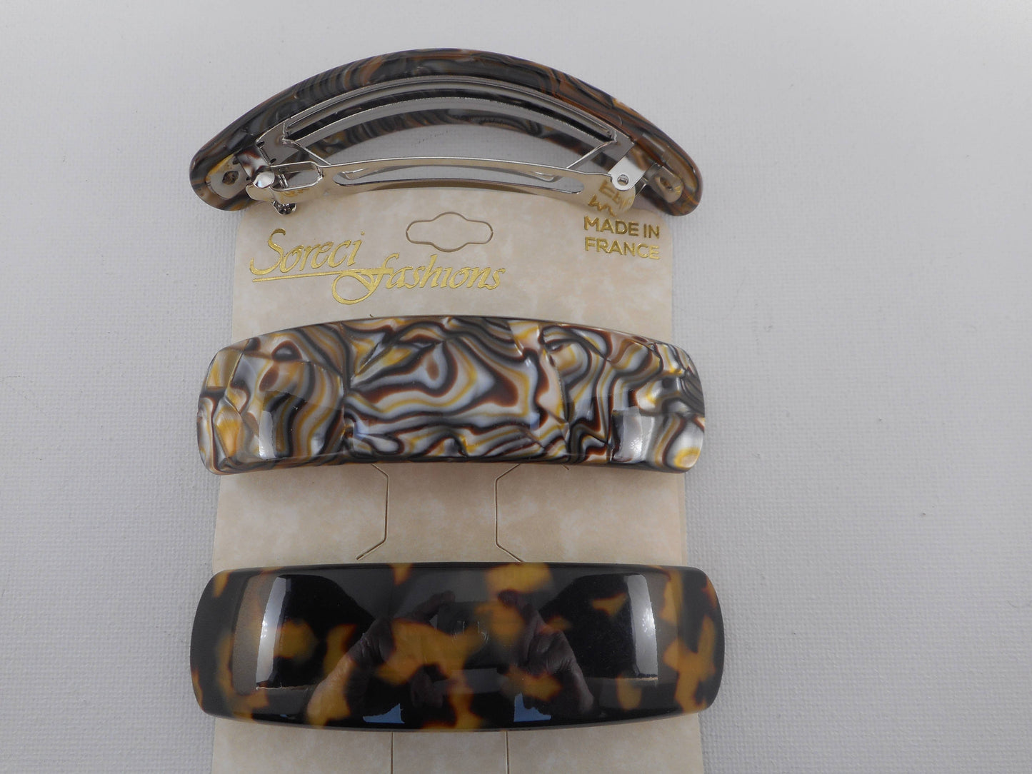 Long semi wide curved barrette.